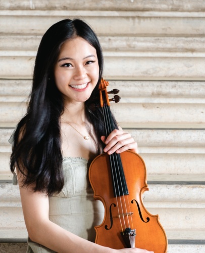 Carlysta Tran Smiling and Holding Her Violin